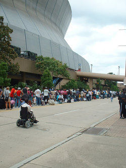 Refugees bringing their belongings and lining up to get into the Superdome.