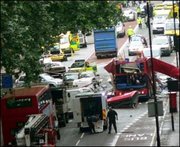 Emergency services surround the wreckage of a bus ripped apart as part of the coordinated terrorist attack on 7 July 2005.