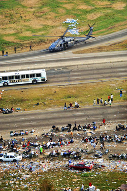 Hurricane evacuees relocated on a highway being helped by the Air National Guard