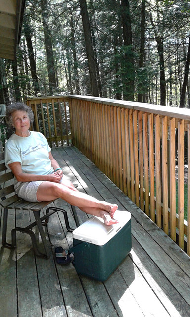 Betsy relaxing of the deck of Cabin No5 at Twin Falls State Park